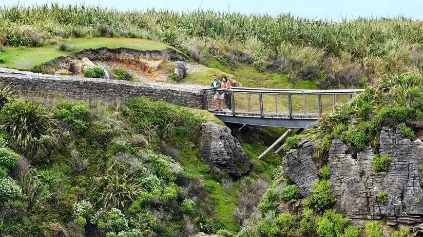 Tourists enjoy the view at Pancake Rocks, Punakaiki, New Zealand.