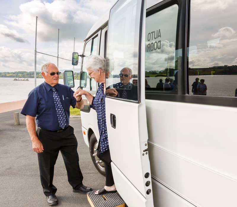 Driver helping passenger off coach.jpg
