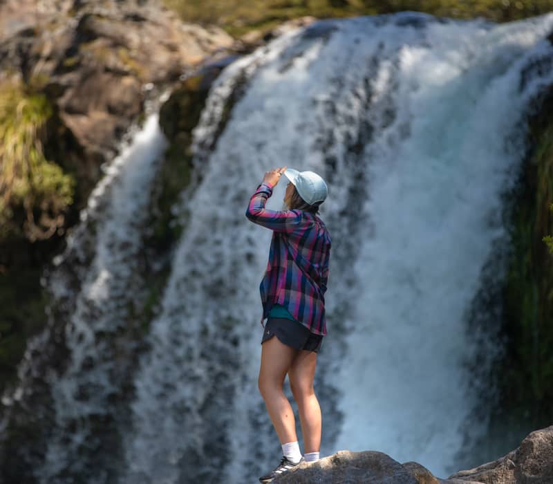 Woman standing at waterfalls. Credit: Visit Ruapehu