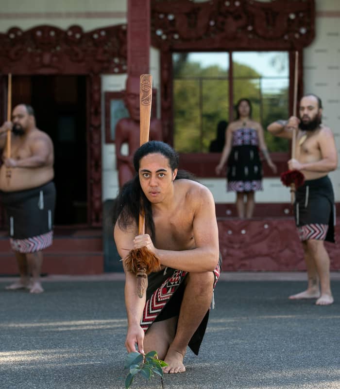Maori performers in traditional clothing and tattoos dancing at Waitangi Treaty Grounds Credit: Waitangi Treaty Grounds